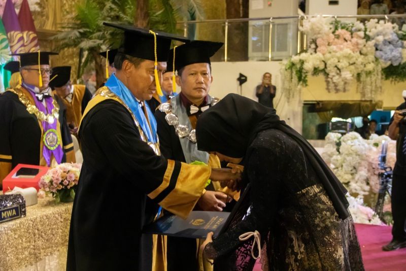 Rektor UNESA, Nurhasan didampingi Dekan FEB, Anang Kistyanto menyerahkan ijazah alm Nur Ifiana kepada Nur Malinda (adik alm).